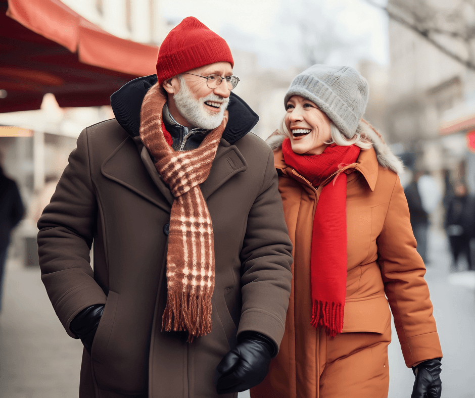 An elderly couple walking in cold layer. They have multiple layers of clothing on to keep them warm.
